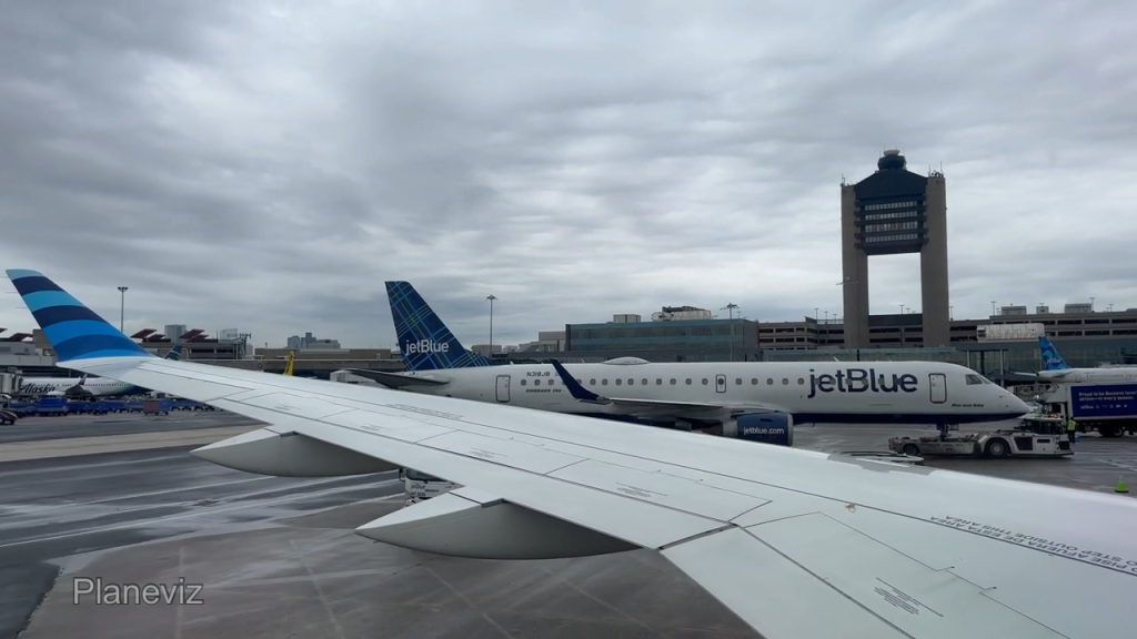 An E190 with Boston tower behind, from the A220